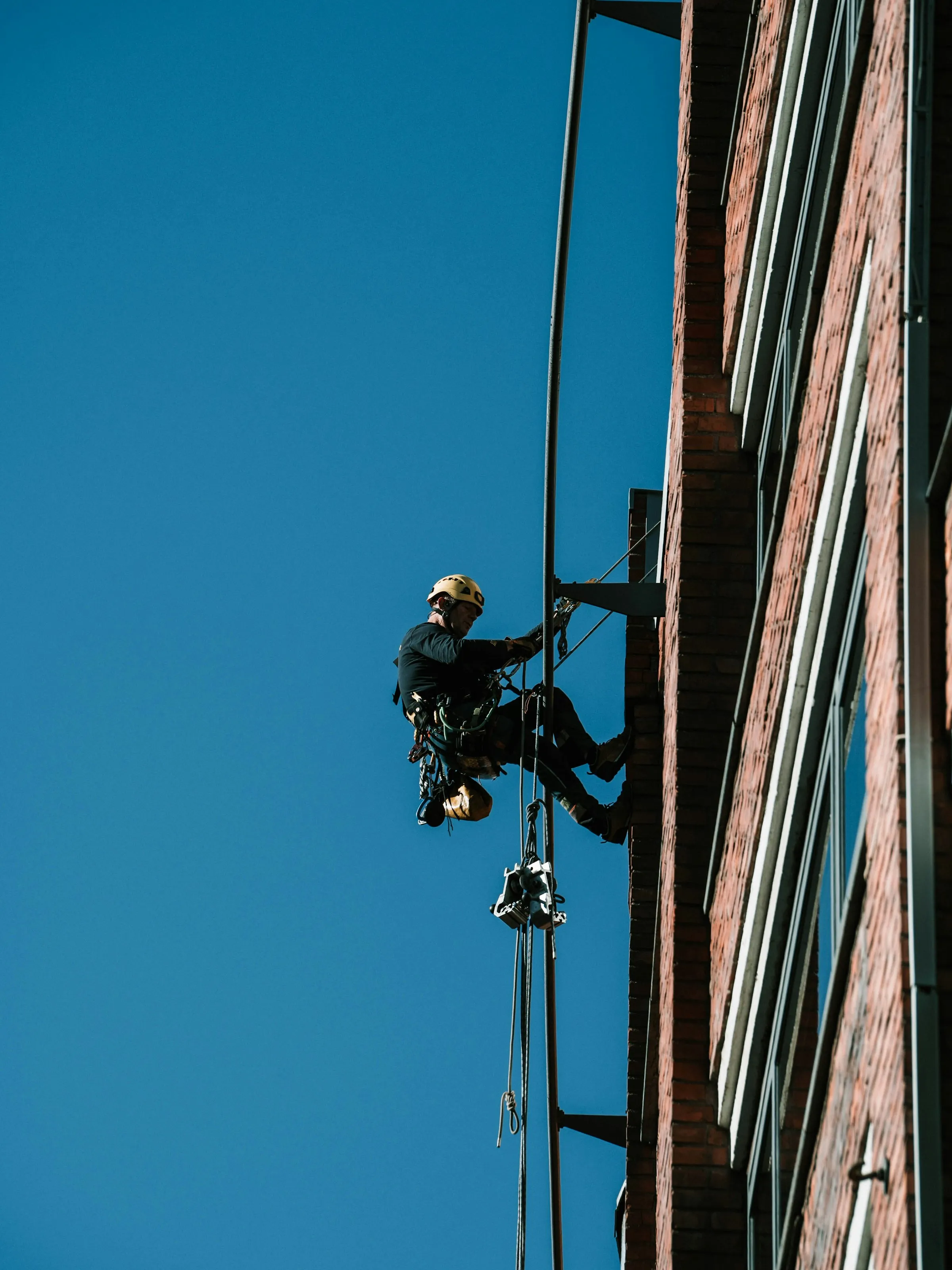 Rope-access technician inspecting a building facade
